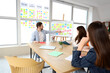 © Pixel-Shot - Agile team meeting in modern office with kanban board, sticky notes and project planning discussion during scrum collaboration session