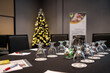 © Rogney - Conference room prepared for corporate holiday event with Christmas tree and table setting