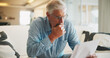 © peopleimages.com - Reading, paperwork and old man with stress, thinking or confused for insurance or bills in home. Policy, pension documents and senior person on sofa with worry or decision for financial report