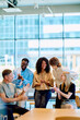 © we.bond.creations - Multiracial young professionals meeting in a modern office, applauding and smiling, showing teamwork, support, and achievement