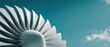 © Alexandra - Close-up of a modern jet engine turbine with sleek blades set against a clear blue sky, symbolizing technology, innovation, and aviation.