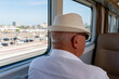 © pavlofox - Elderly man in hat on train journey