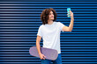 © VISTA by Westend61 - Smiling young man with skateboard taking selfie through smart phone