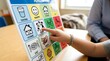 © Shemli - Young child learning and communicating using a visual picture board, fostering development and understanding through interactive therapy for special needs