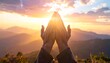 © Misa - Hands reaching for the sky during a vibrant sunset over mountains.