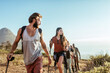 © Marko Geber - Group of friends hiking on coastal mountain trail at sunset