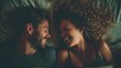 © Dao - A happy couple in love communicate face-to-face while relaxing in bed.