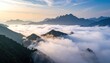 © samsoru - Majestic mountain peaks pierce through a sea of clouds at sunrise.