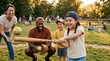 © Margarita Ratatosk - Happy family playing baseball in summer park during sunset. Mother, father and child practicing hitting ball with wooden bat. Active lifestyle and sport recreation for children.