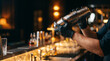 © Hypnotics 14 - Professional Bartender in Black Gloves Shaking a Steel Cocktail Shaker in an Upscale Bar