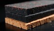 © Viktor - Macro view shows layered composite material samples. Dark rough surfaces with red specks rest on rough brick layer. Materials differ in texture and grain.