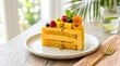 © Nique - Velvet mango cake slice with tropical fruit garnish, bright summer colors, clean editorial food photography, realistic dessert texture