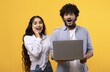 © Prostock-studio - Surprised Young South Asian Couple Displaying Joyful Reactions While Looking At Laptop In Modern Office Setting. Positive Emotion Reflected On Faces, Indicating Excitement And Discovery.