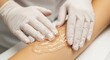 © syempurnax - Cosmetologist applying sugaring paste for leg hair removal in a beauty salon.