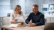 © Andrey Popov - Two Professionals Discuss Confidential Workplace Misconduct Report During