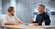 © Andrey Popov - Two HR Managers Discuss Employee Severance