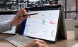 © Andrey Popov - Young Procurement Manager Reviews Supplier Contracts Using Laptop
