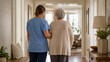 © Рудой Максим - Caregiver assists elderly woman in a hallway during daytime at a senior living facility