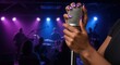 © Nataly - Singing performance with microphone held by artist in front of enthusiastic audience. Music event features vibrant stage lights and energetic atmosphere.