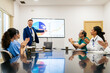 © Koldo_Studio - Medical team of doctors, nurses, and surgeons clapping for a presenter discussing health data and professional success in a meeting