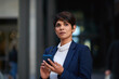 © peopleimages.com - Businesswoman, commute and thinking in city with phone, legal aid website or update for court case. Space, mature person or attorney travel in urban town with tech, text message and remember lawsuit.