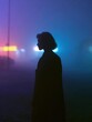 © CYBERPINK - Silhouette of a person standing in the middle of a foggy field. the person is facing away from the camera, with their back towards the viewer. the sky is a deep blue, with a few wispy clouds.