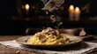 © Vagner - Chef shaves fresh black truffle over fettuccine pasta in dimly lit restaurant