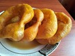 © Juan Lino - Picarones, postre típico de la gastronomía peruana, en base a masa dulce frita bañada con miel de higo