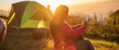 © aFotostock - Banner Women camping outdoor sitting Tent Camp trip hiking mountain hill on sunrise. Picnic green Adventure Travel forest with copy space. Panorama Tent camp nature background flare sunlight mountain