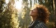 © kwanchaift - Woman Enjoying Nature and Fresh Air in a Serene Forest Setting with Sunlight Filtering Through Trees