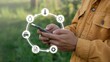 © Soyaeb - Farmer's hands using a smartphone to monitor and manage smart farm operations with digital technology, displaying agricultural data and IoT solutions in a rural field