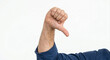 © Nadezda Ledyaeva - Close up of male hand showing thumbs down gesture on white background