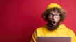 © Larisa AI - A surprised young man with curly hair and glasses is peering at a laptop, capturing the essence of shock or excitement against a vibrant red background.