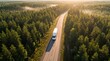 © alishanmrafiqvirani - Aerial View of Autonomous Electric Freight Truck on Forest Highway