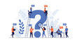 © Elwood - Group of professional people use laptops and tools to research answers around a giant blue question mark symbol.