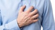 © adinf - Man holding chest in pain, possible heart attack