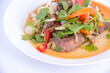 © krilerg - Spicy thai beef salad with fresh herbs and vegetables.