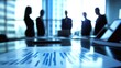 © arthit - Business meeting silhouette in modern office with document focus on table and people discussing strategy and ideas collaboratively