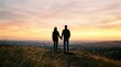 © ymamoto - Couple holding hands on a hilltop watching the sunset over a city vista at dusk