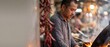 © Fernando - Asian chef cooking street food with wok in outdoor market stall at night, professional male cook preparing hot spicy chinese dish with flame, authentic culinary portrait with red chili banner backgrou