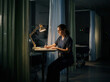 © Aulia - A Medical Professional Works Late, Writing Notes In A Dimly Lit Hospital Room