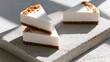 © Anat art - Three protein cheesecake slices are displayed on a textured surface with natural light highlighting their design and appealing texture