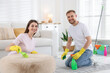 © New Africa - Spring cleaning. Couple tidying up room together at home