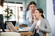 © JackF - Curious female employee sharing gossip with surprised young colleague during workday in office