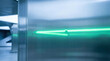 © newlifestock - Steel surface reflecting neon green light in modern industrial setting with cool blue tones creating sleek and futuristic atmosphere