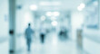 © birulaut - A blurred image of a hospital corridor, featuring indistinct figures and soft lighting, conveying a sense of depth and atmosphere in a clinical environment.