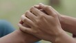 © Tati - Close-up of two people holding hands outdoors, a gentle supportive touch conveying comfort, connection, and tenderness