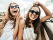 © halayalex - Portrait of two young beautiful and smiling hipster female in convertible car. Sexy carefree women driving cabriolet. Positive models riding and having fun in sunglasses outdoors.Enjoying summer days