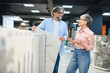 © Serhii - Senior couple choosing flooring tiles for home renovation