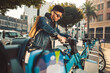 © Westend61 - Stylish young man on the street with rental bike